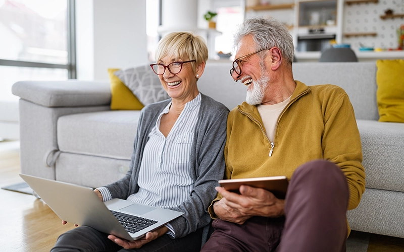 smiling couple on laptop