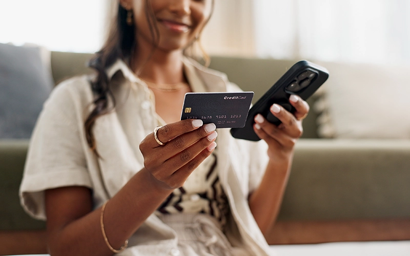 woman with phone and credit card